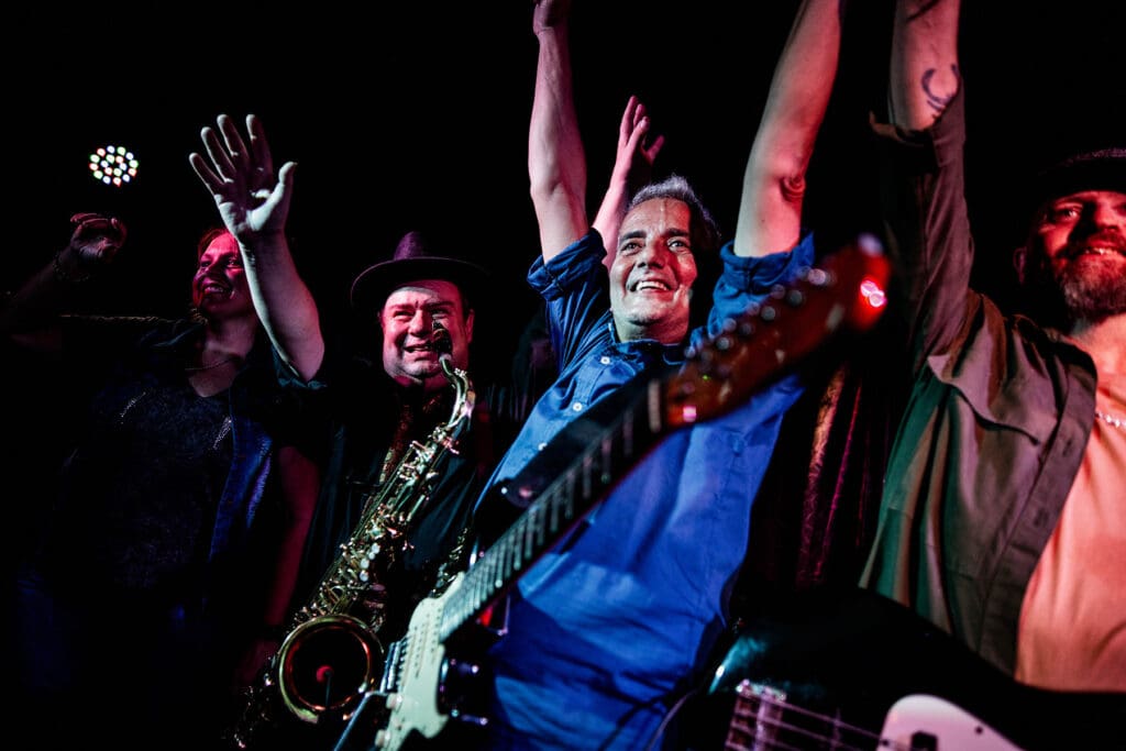 Rock band performing and thanking audience on nightclub